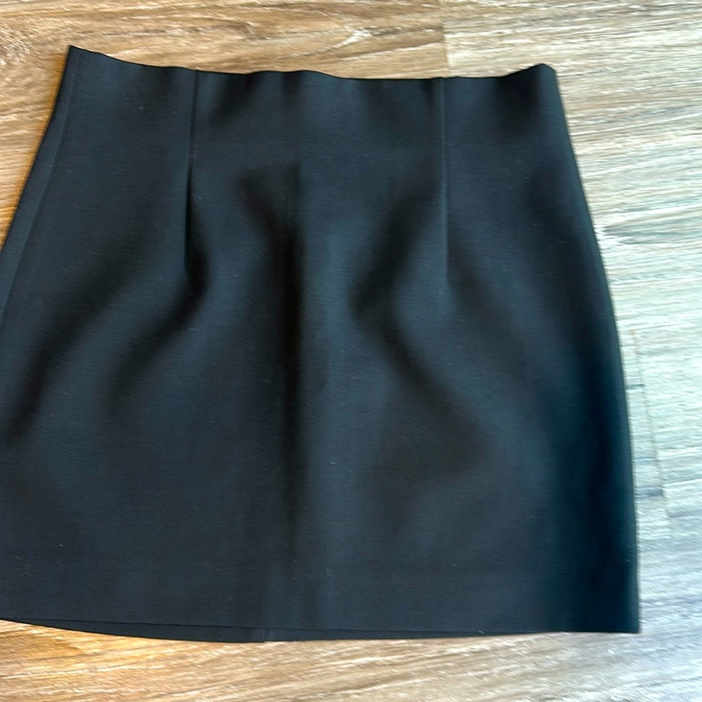 Mini skirt with a high waist. Side hidden in-seam zip closure.